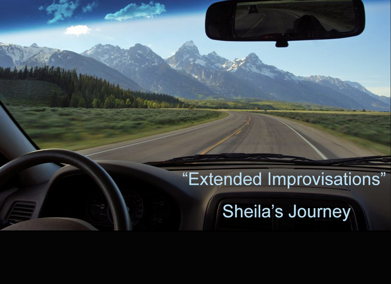 Mountain range view from inside car's windshield